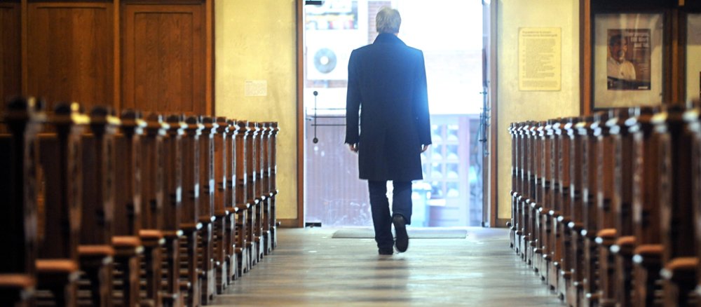A man leaves a church.