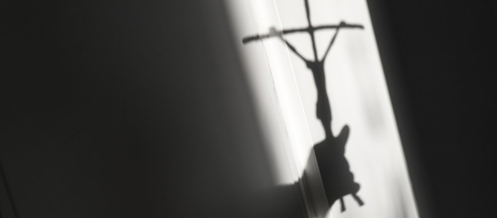 Shadow of a crucifix on a wall