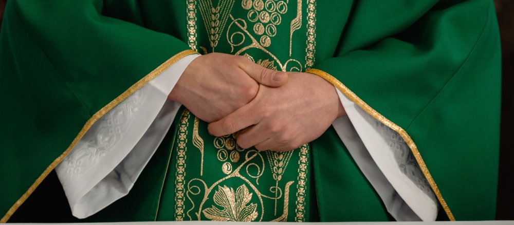Priest in chasuble with folded hands