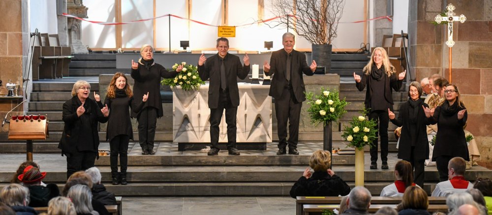 Ein Gehörlosenchor steht auf den Altarstufen während eines integrativen Gottesdienstes für Gehörlose