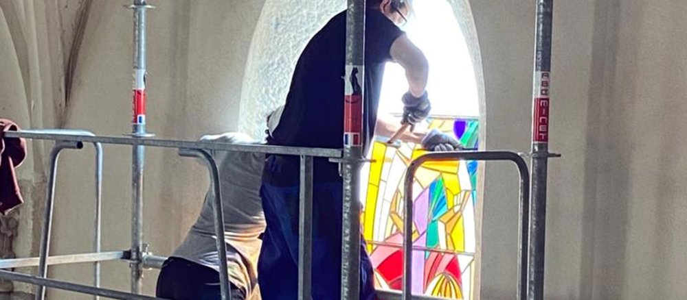 Ein Arbeiter entfernt ein Kirchenfenster von Louis Ribes in Sainte-Catherine (Rhone)
