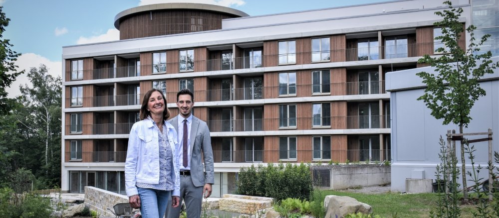 Birgit Heigl and her son Julian Heigl stand in front of the Haus Simeon retirement home for priests in Kempten