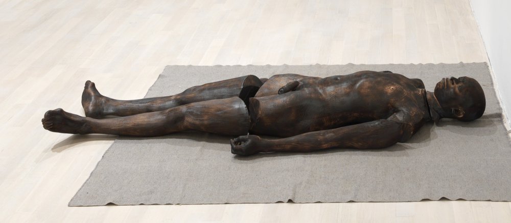 Skulptur eines liegenden Mannes