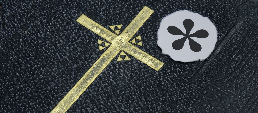 Ein Gendersternchen liegt neben dem Kreuz auf einer Bibel