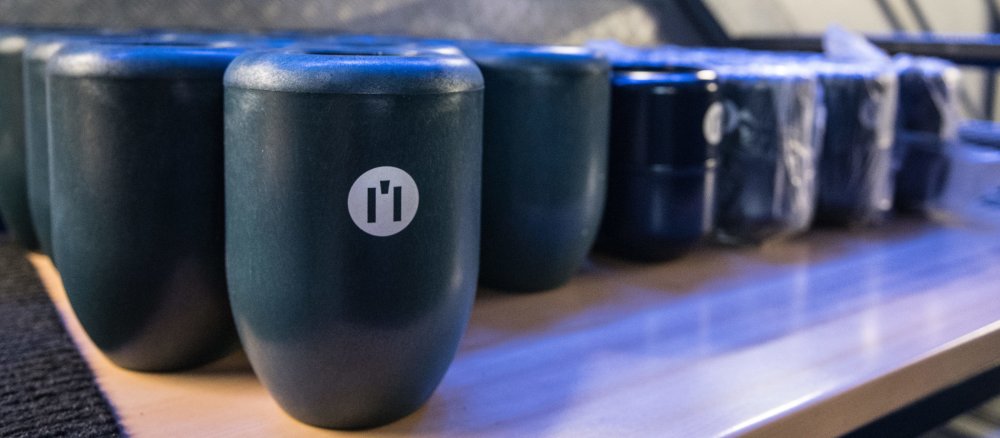 A row of so-called "inner urns" stands on a table.
