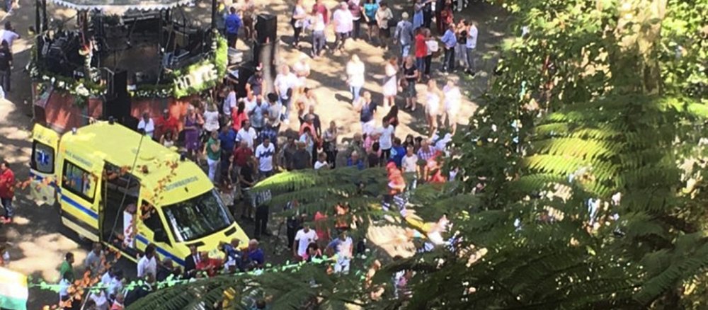 An ambulance attends the scene after a tree fell on a large crowd gathered as part of a traditional religious festival in the outskirts of Funchal, the capital of Madeira island, Portugal.