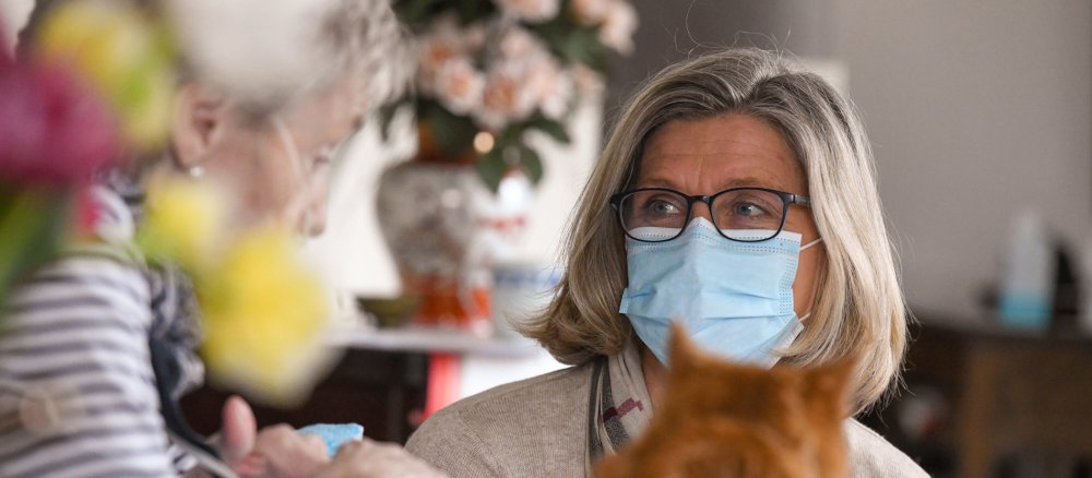 Eine Palliativschwester spricht mit einer kranken Frau