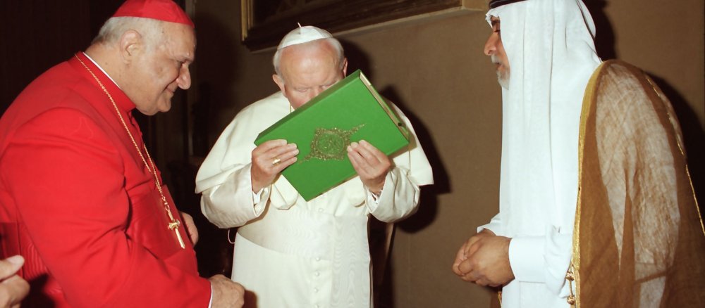 Pope John Paul II kisses the Koran