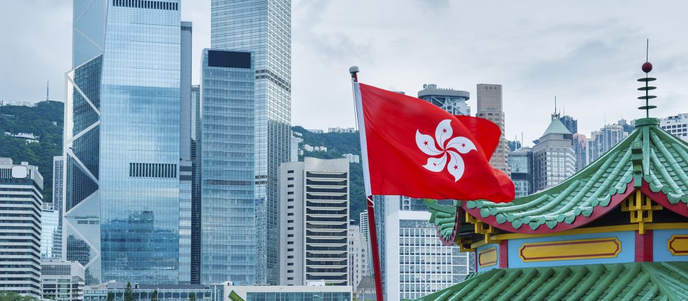 The flag of Hong Kong against a metropolitan backdrop.