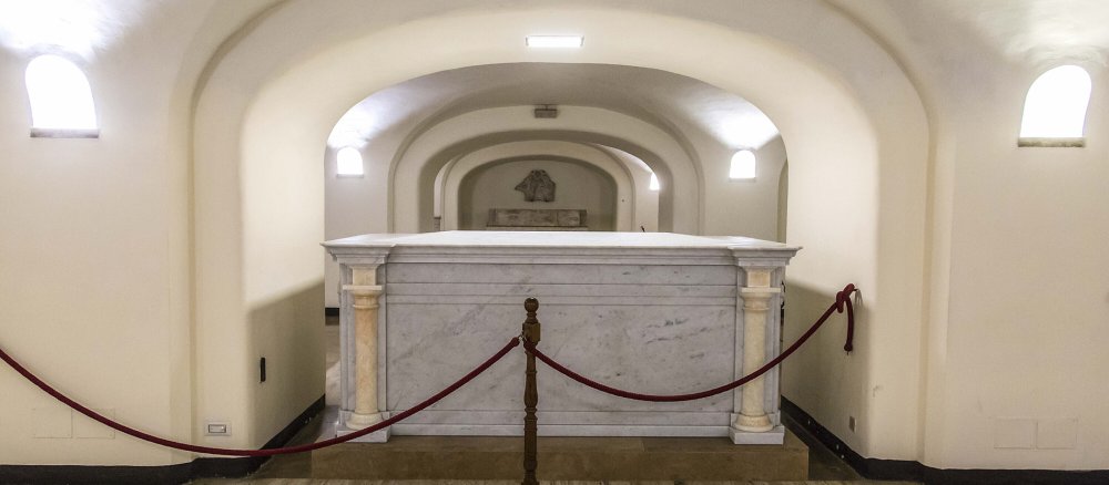 A white marble sarcophagus in the Vatican Grottoes