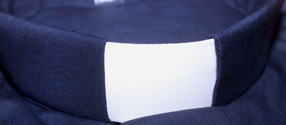 Kragen eines Priesters. Kollar. Außerhalb liturgischer Handlungen getragenes schwarzes Brusttuch oder Hemd mit Stehkragen mit einem weißen quadratischen oder rechteckigen Kragenstück, dass in den Bund integriert ist.