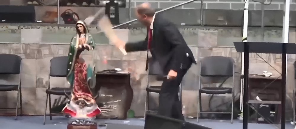Pastor Kevin Wynne destroys a statue of the Virgin of Guadalupe with an axe