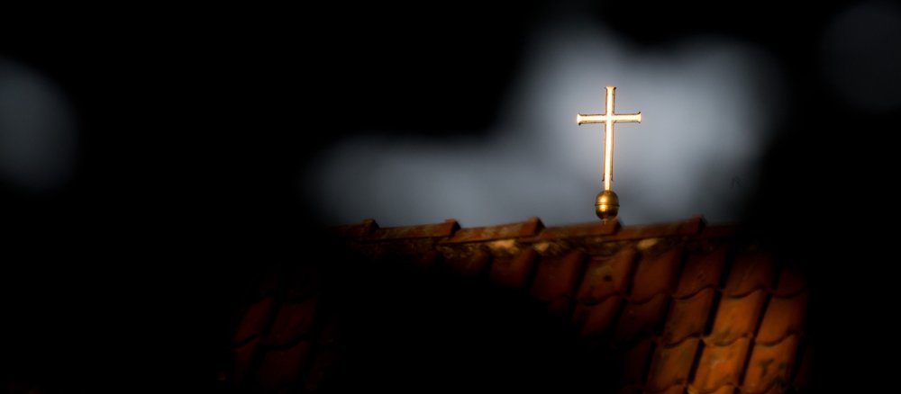 A cross shines in the sun