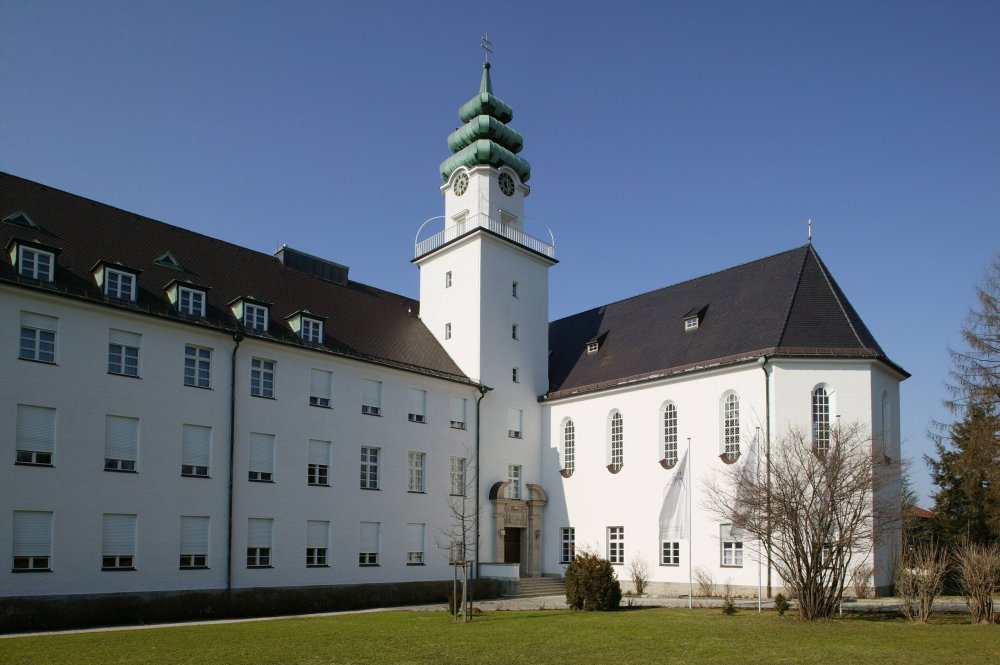 Das Studienseminar Sankt Michael in Traunstein mit weißen Gebäuden und Turm.