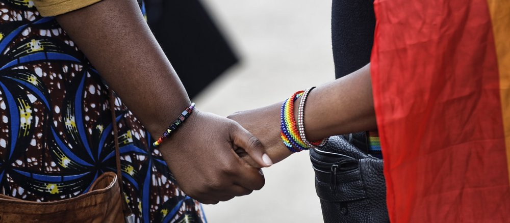 Kenyan women hold hands