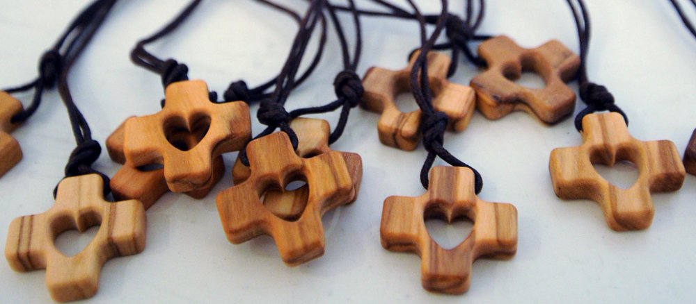 Holzkette in Kreuzform mit einem Herz in der Mitte