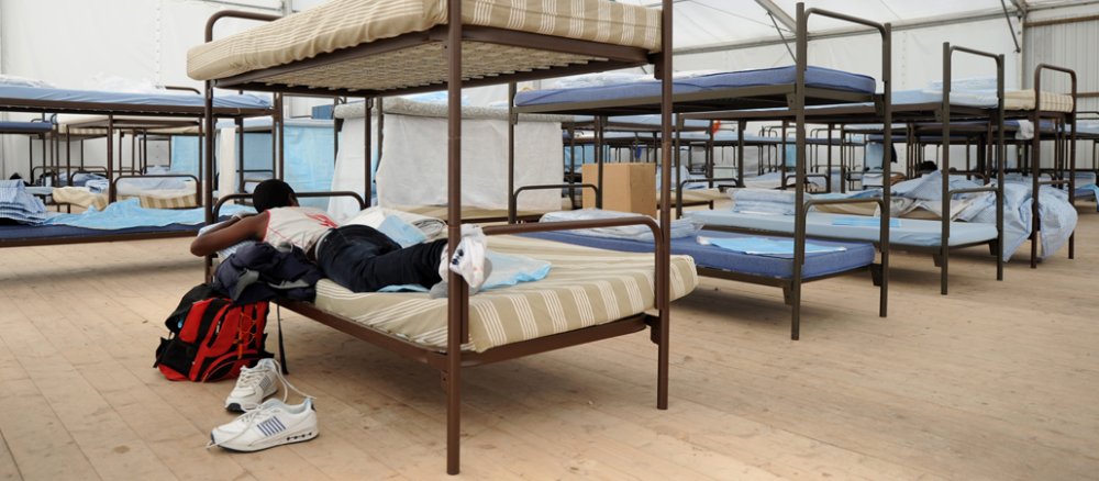 A refugee lies in his picture in a mass accommodation centre in Munich.