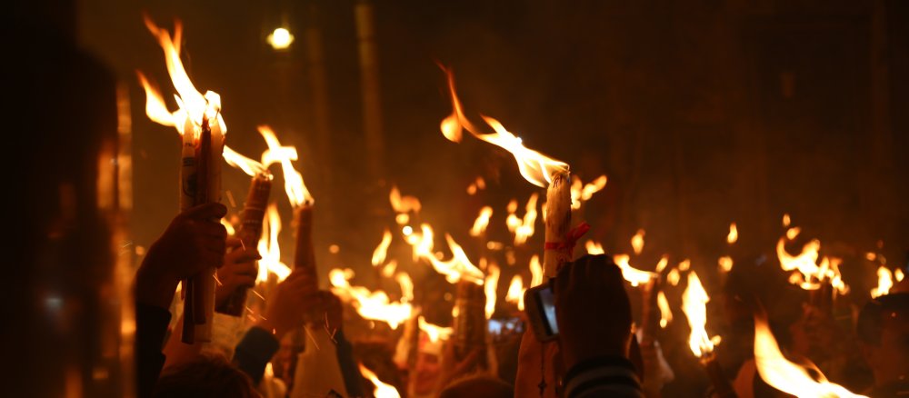 Burning candles in the Church of the Holy Sepulchre in Jerusalem during the Orthodox Easter celebration