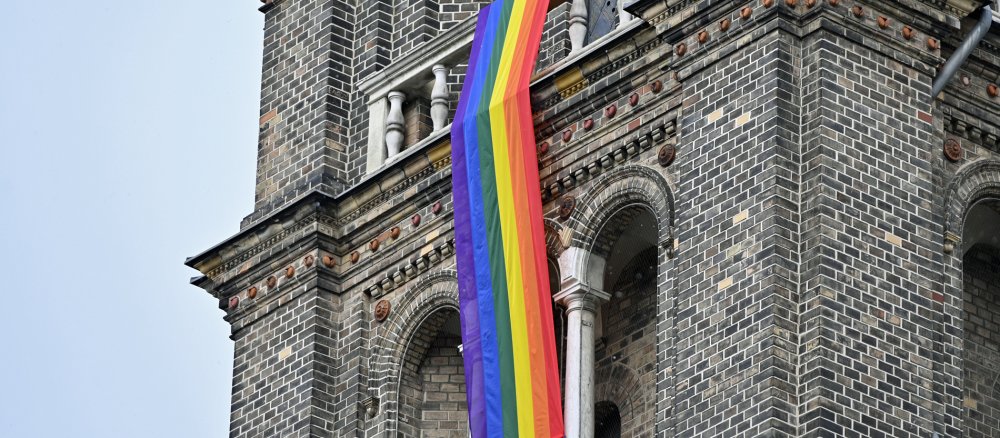 Regenbogenfahne an Kirche