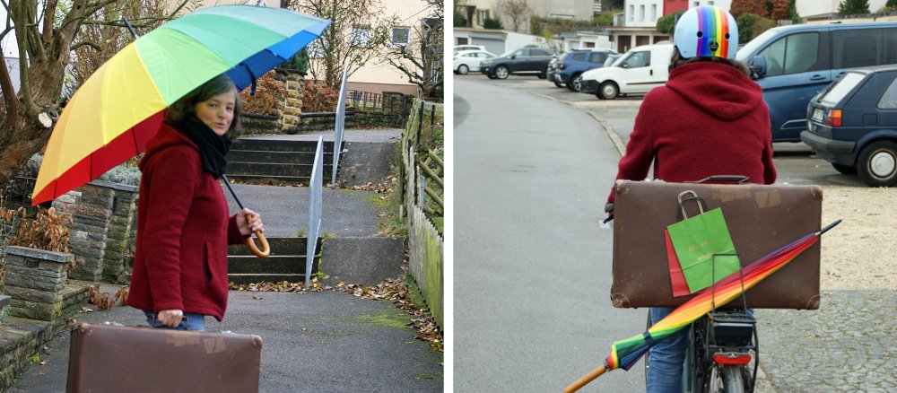 Claudia Ebert mit einem Regenschirm und einem Reisekoffer